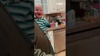 Giggling baby throws head back in laughter