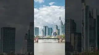 Hyperlapse of Frankfurt's skyscrapers skyline with the bell tower overlooking Alte Brucke. Frankfurt