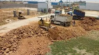 Land Filling Operation Begins!! Teamwork skilled dozer operator and dump truck drivers moving soil.