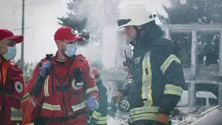 Paramedics speaking with rescuer after disaster