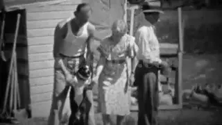 1934: Family plays with dog while man casually feeds chickens.  DENVER, COLORADO