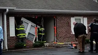 Watch firefighters remove debris from apartment damaged by car crash