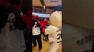 Monty and Sioux City explorers mascot exchanging with each other.
