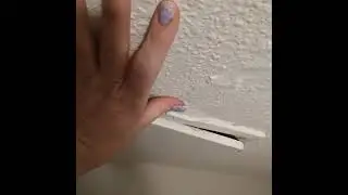 Soggy, moldy, waterlogged ceiling in apartment bathroom due to AC leaking into ceiling space.