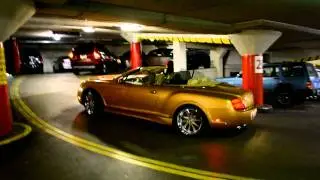 GOLD custom Bentley GTC in a parking garage