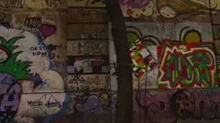 Slow motion tracking shot of graffiti on a wall along a street in Rio de Janeiro, Brazil