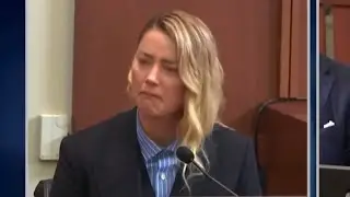 Amber Heard lying on the stand.