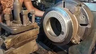 Truck wheel drums or brakes are being made. In the lathe machine. Work being done by skill man