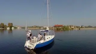 Aerial, sailing yacht on water, crew training on deck, yachting. Stock Footage