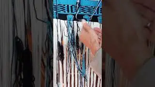 Weaving the lower shape of the copper design in naaxiin (chilkat) techniques