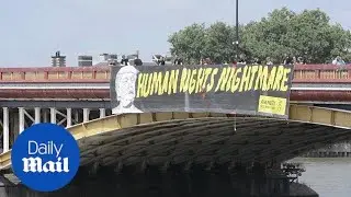 Activists drop 'human rights nightmare' banner from bridge