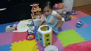 Chloe busy playing with her toys (12/2018)