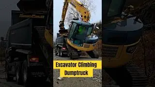 Excavator Climbing Dumptruck