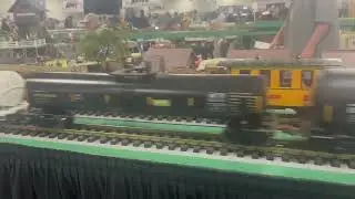 01/25/26 Old mining steam engine train at the Big E train show. CSX train passes by it.