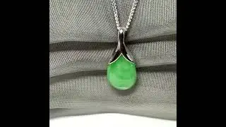 A real green jade necklace in a teardrop or a pear shape with a solid chain included
