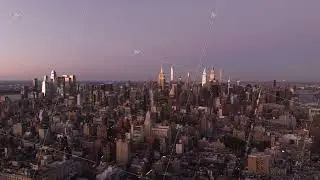 Midtown Manhattan skyline, including Empire State Building, glowing under soft morning light