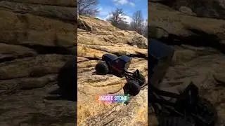Black RC Truck Navigating Steep Rocky Terrain