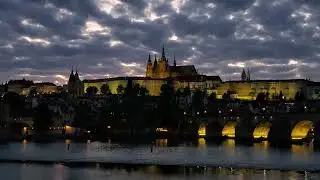 Prague Castle and Charles Bridge lighting up at night