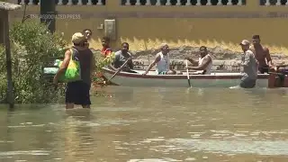 Neighborhoods in Brazil's Rio de Janeiro state are flooded after rains that killed 12 people