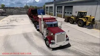 Transporting heavy machine in American Truck Simulator.