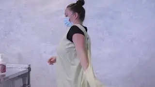 Donning and doffing reusable wraparound cloth isolation gowns