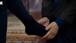 Actress takes her boots off (black socks)