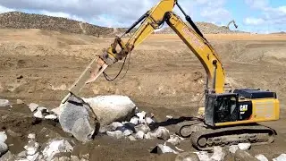 CAT 349F excavator breaking boulders with 16k pound breaker