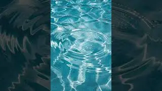 Calm water ripples on a light blue water surface /