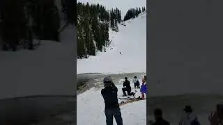 Snowbird Ski Patroler saving the day with sled. Pond Skimming