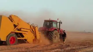 Massive boulder loaded by a rock picker