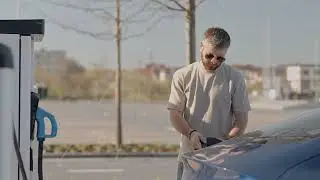 Man connecting electric car