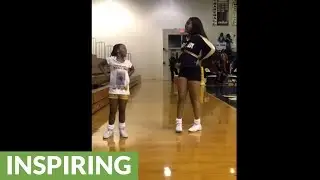 Little girl joins in on big sister's cheer solo