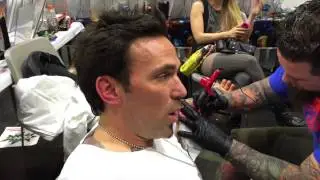 Jason David Frank gets tattooed in the GeeksterInk Legends booth.