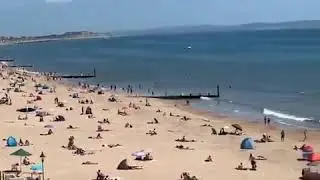 Crowds made their way to the beach in Dorset, England, with social distancing guidelines