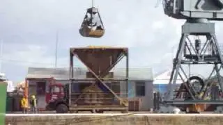 Dockside Crane unloads Sand, Skidsteer and Wood