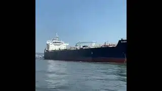 Marine Tanker chanelling through in a slow pace as it navigates through to the docking jetty.