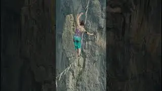 Woman in slack line high line over cliff tight rop