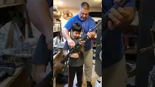 Uncle Eric is showing Jacob his Remington AR-15