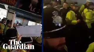Police guide three far-right demonstrators out of a crowd of counter-protesters in Brighton