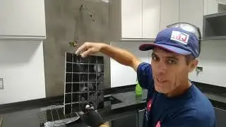 colocando pastilhas em parede de cozinha