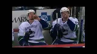 The Sedin Twins having a drink at the bench