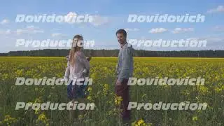 A happy family walks on a rapeseed field.