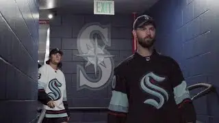 New Seattle Kraken Players throw out the ceremonial first pitch at a Seattle Mariners Game.