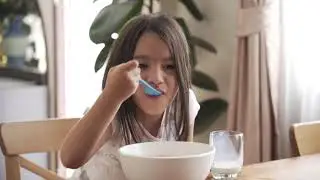 Copyright free 4k stock footage || a girl eating a bowl of cereal