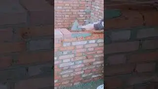Gloved hand aligning brick courses using taut guide string #construction #popular