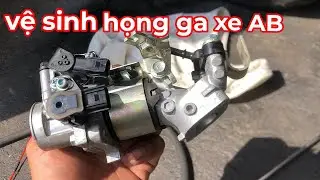 Cleaning the throttle body of an AB scooter.