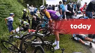 Spectator with signboard causes massive crash at Tour de France