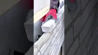 Detailed View of a Masonry Process Showing Brick Placement and Thin Mortar Jointing