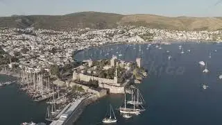 D-Log M. Bodrum, Turkey. Aerial view of Bodrum Castle fortress walls and towers with yachts in fo...