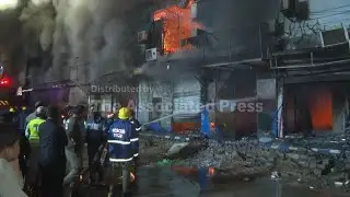 Massive fire engulfs dozens of shops at a shopping mall in southern Pakistan, killing 3 people